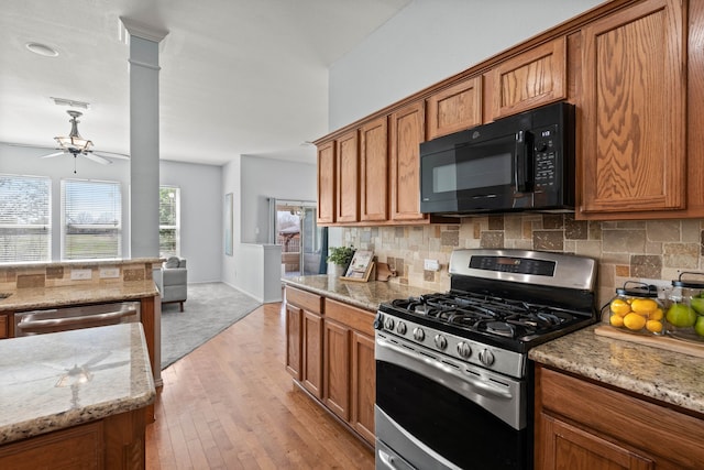 kitchen featuring tasteful backsplash, appliances with stainless steel finishes, and brown cabinetry