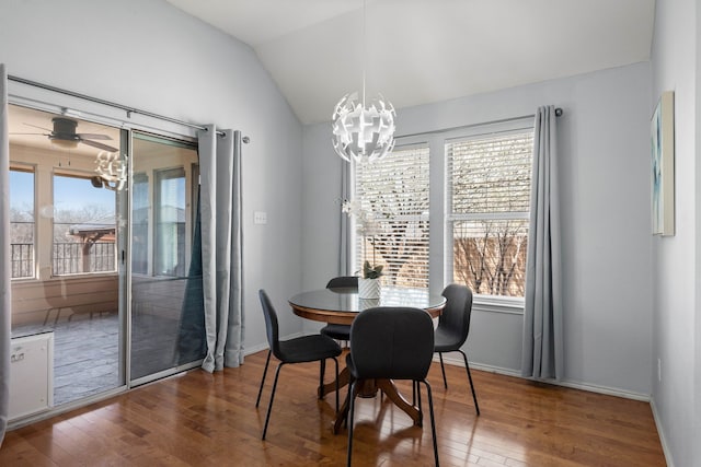 dining space featuring a notable chandelier, plenty of natural light, and lofted ceiling