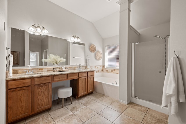 bathroom featuring a sink, lofted ceiling, double vanity, and a shower stall