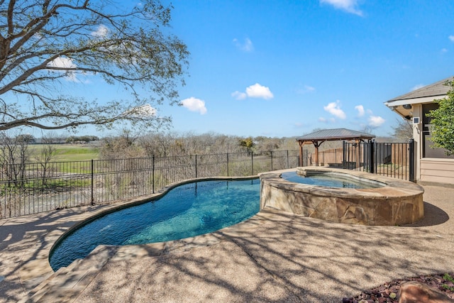 view of pool with a gazebo, fence, and a pool with connected hot tub