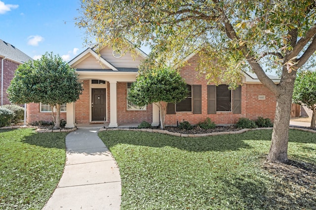 view of front of house with brick siding and a front yard