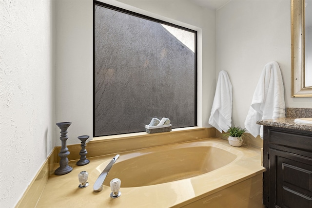 full bathroom with vanity and a garden tub