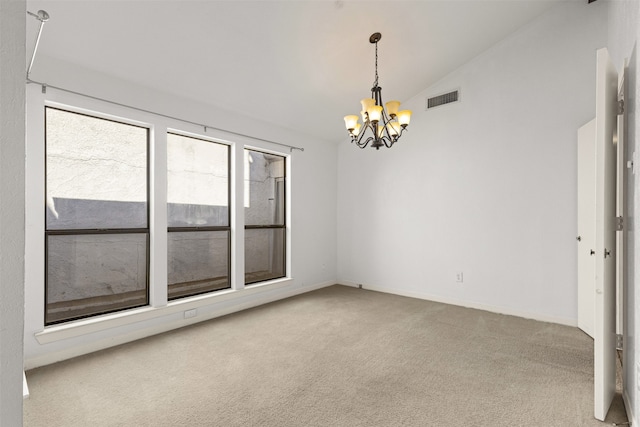 carpeted empty room with lofted ceiling, baseboards, visible vents, and a chandelier