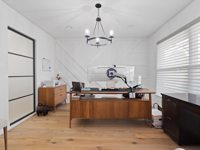 office featuring light wood-style flooring and an inviting chandelier