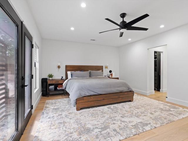 bedroom with access to exterior, recessed lighting, light wood-style floors, and visible vents