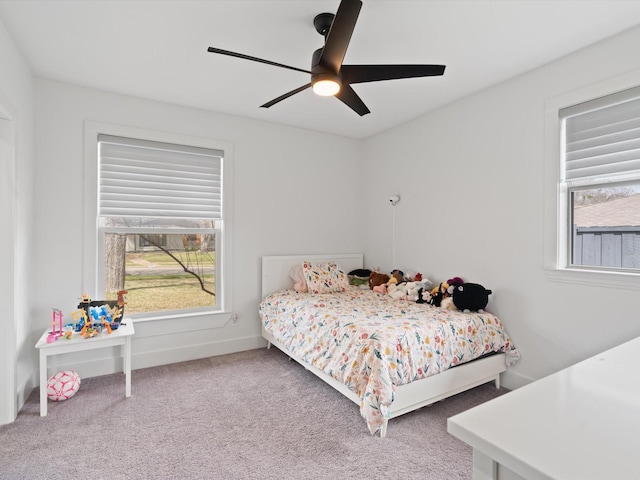 carpeted bedroom with baseboards and ceiling fan