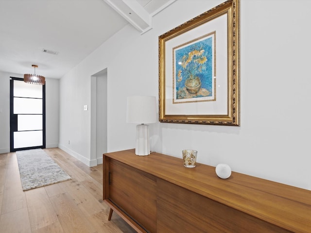 foyer entrance featuring light wood-style flooring, baseboards, and visible vents