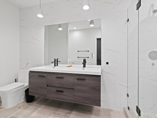 bathroom featuring double vanity, toilet, a sink, and a walk in shower