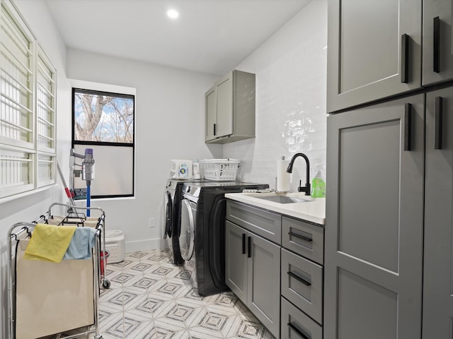 washroom with washing machine and clothes dryer, baseboards, recessed lighting, cabinet space, and a sink