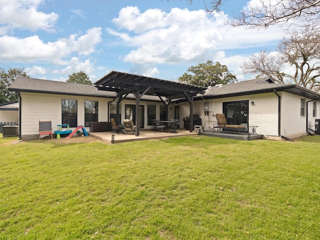 rear view of property with a pergola, central AC, a yard, brick siding, and a patio area