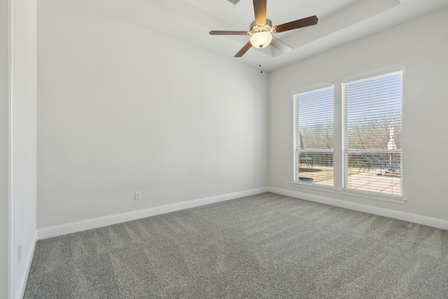 unfurnished room with a ceiling fan, carpet, and baseboards