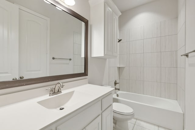 full bath featuring tile patterned floors, toilet, vanity, and washtub / shower combination