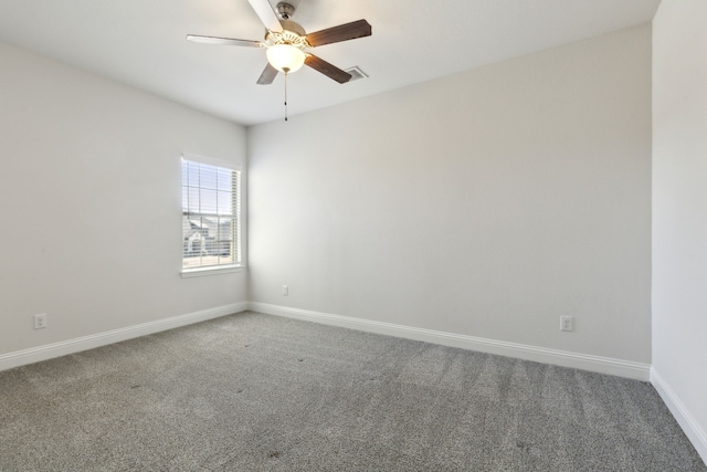 empty room with carpet flooring, baseboards, and a ceiling fan