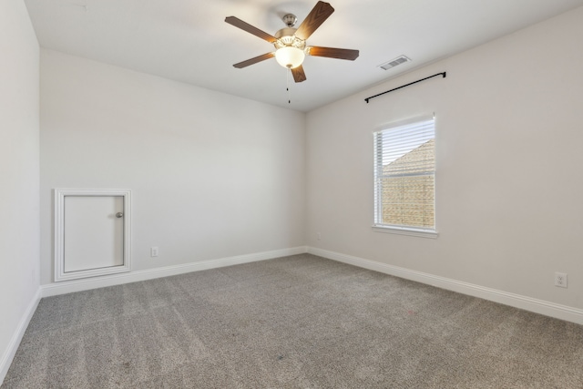 empty room featuring visible vents, carpet flooring, baseboards, and a ceiling fan