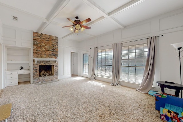 living room with a decorative wall, coffered ceiling, a ceiling fan, and carpet floors