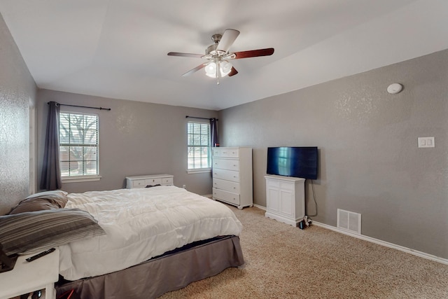 bedroom with light carpet, visible vents, ceiling fan, and baseboards