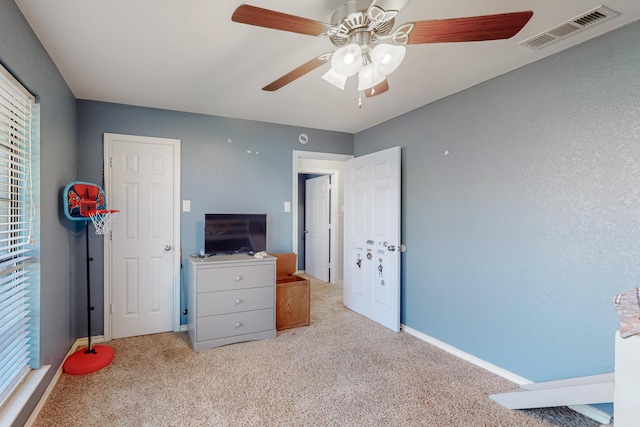 bedroom with visible vents, carpet floors, baseboards, and a ceiling fan