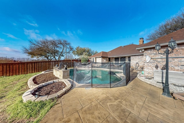 view of pool featuring a fenced in pool, a fenced backyard, and a patio area