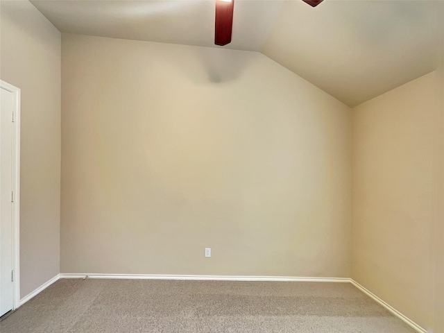 carpeted spare room featuring lofted ceiling, baseboards, and ceiling fan