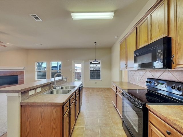 kitchen featuring light tile patterned floors, visible vents, a sink, decorative backsplash, and black appliances