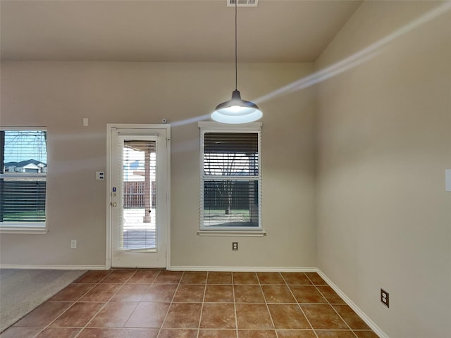 interior space with tile patterned flooring, visible vents, and baseboards