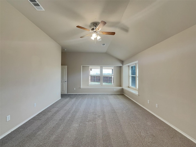 carpeted spare room featuring a ceiling fan, visible vents, and baseboards