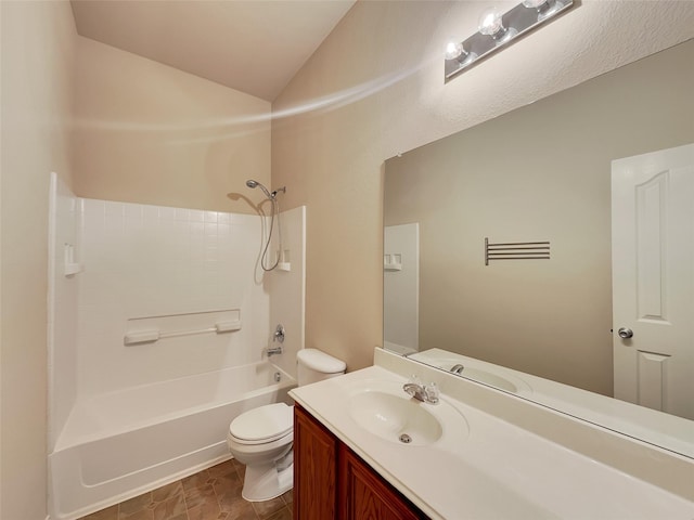 bathroom with bathtub / shower combination, toilet, vanity, and lofted ceiling