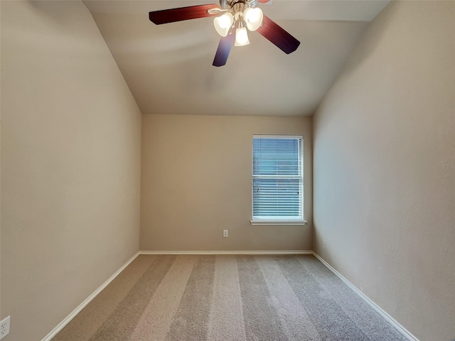 empty room featuring baseboards, lofted ceiling, a ceiling fan, and carpet floors