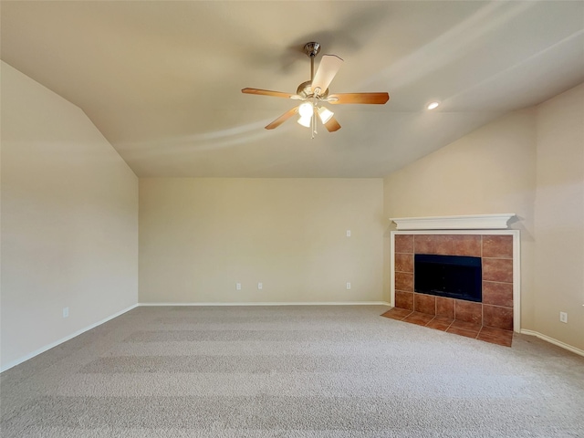 unfurnished living room featuring carpet, baseboards, a ceiling fan, a fireplace, and vaulted ceiling