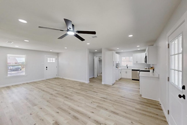 unfurnished living room featuring recessed lighting, baseboards, light wood-style flooring, and a ceiling fan