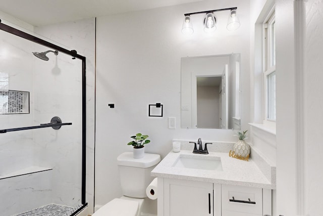 full bathroom featuring a marble finish shower, toilet, and vanity