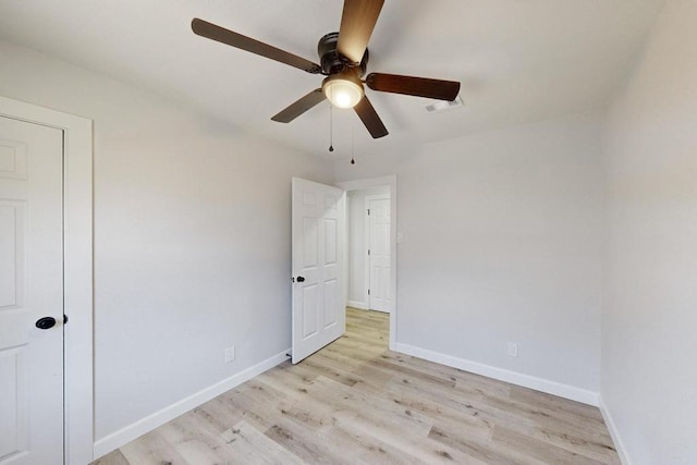 interior space featuring light wood-type flooring, visible vents, baseboards, and a ceiling fan