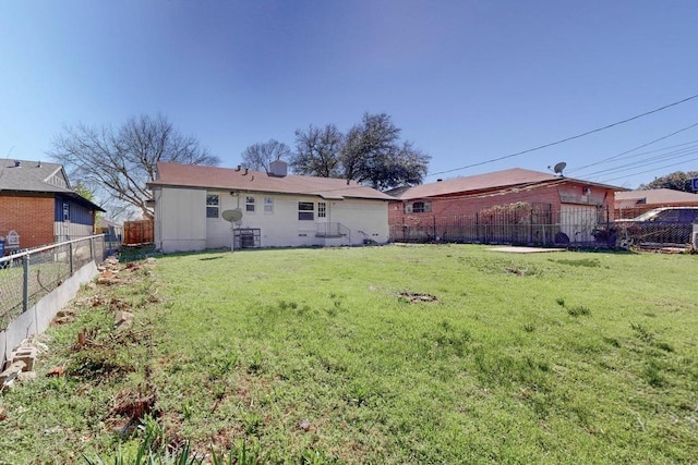 back of property featuring a fenced backyard and a yard