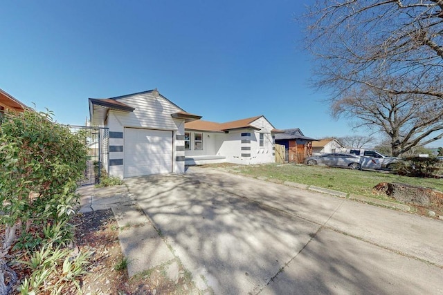 view of front facade with a front yard, an attached garage, and driveway