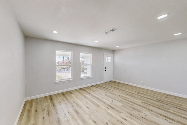 unfurnished room featuring recessed lighting, baseboards, visible vents, and light wood-type flooring