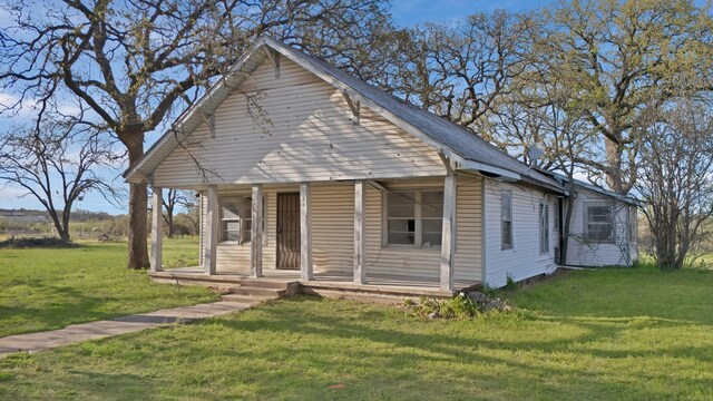 202 Johns Dr, Chico, TX 76431 - view of front of property featuring covered porch and a front lawn