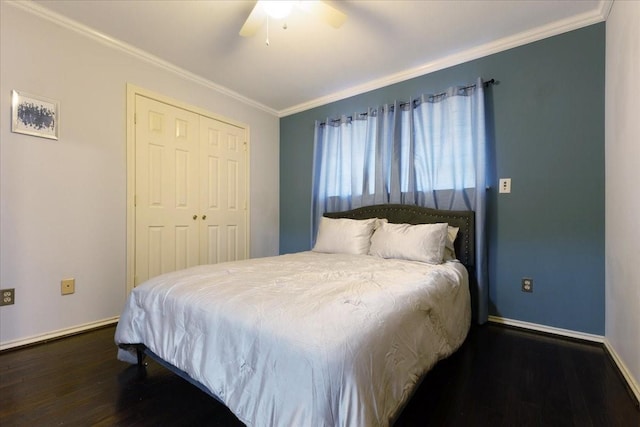 bedroom with crown molding, baseboards, dark wood-style flooring, and a closet