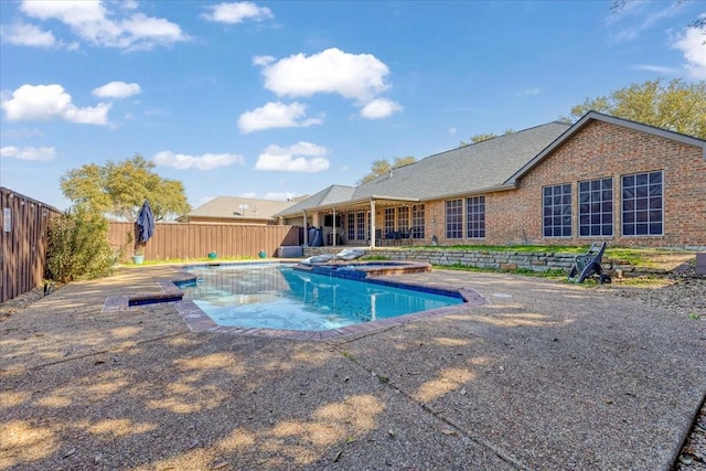 view of pool featuring a patio area, a fenced in pool, an in ground hot tub, and a fenced backyard