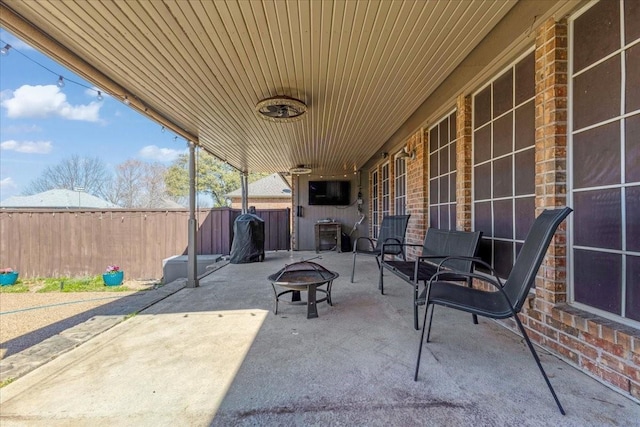 view of patio featuring fence and an outdoor fire pit