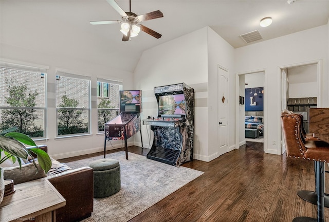 living room featuring visible vents, baseboards, ceiling fan, lofted ceiling, and wood finished floors