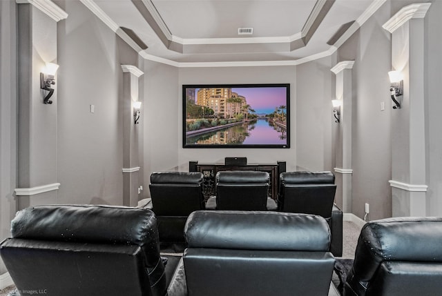 carpeted cinema room featuring visible vents, a tray ceiling, crown molding, and baseboards