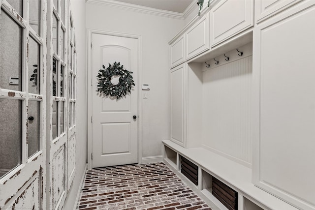 mudroom with brick floor, baseboards, and ornamental molding