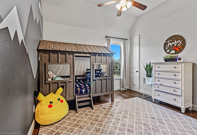 bedroom with lofted ceiling, wood finished floors, baseboards, and ceiling fan