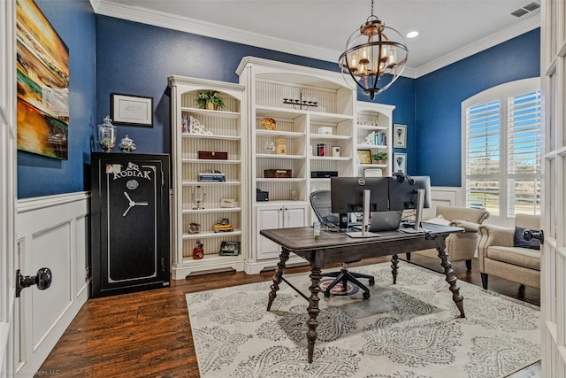 office space with a chandelier, visible vents, crown molding, and a wainscoted wall