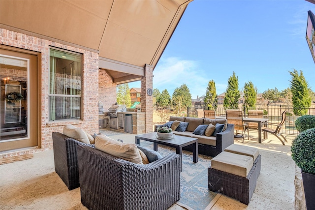 view of patio / terrace with grilling area, fence, exterior kitchen, an outdoor hangout area, and outdoor dining area