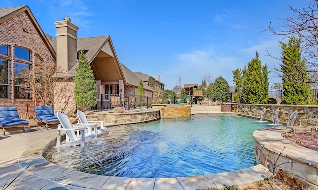 view of pool featuring a fenced in pool, a patio, fence, and a playground