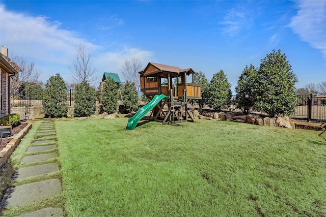 communal playground with a yard and fence