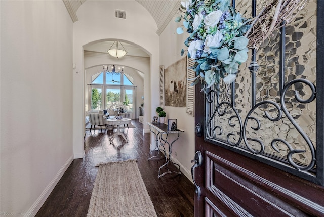 entrance foyer with visible vents, wood-type flooring, arched walkways, and baseboards