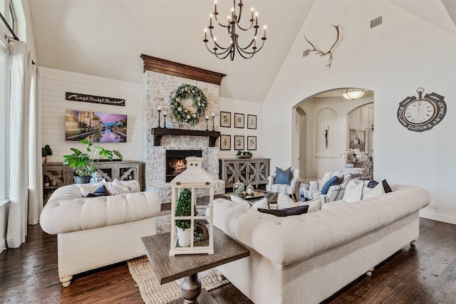 living room featuring visible vents, an inviting chandelier, arched walkways, high vaulted ceiling, and dark wood-style flooring