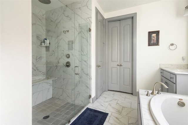 bathroom featuring a marble finish shower, marble finish floor, a bath, and vanity